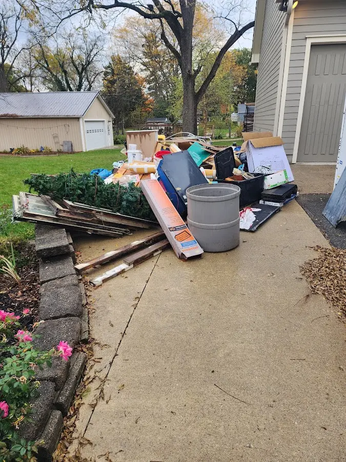 Dumpster being loaded with debris for 12 Yard Dumpster Rental in Waterford